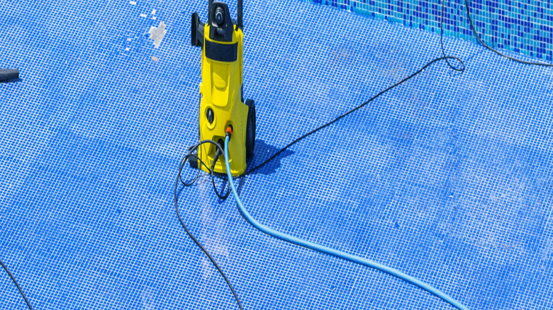 Using a transfer pump to drain water from a pool