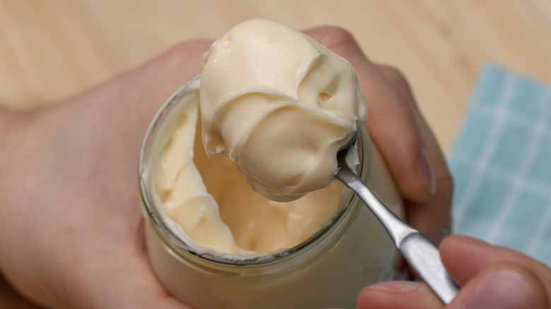 spoonful of mayonnaise from jar