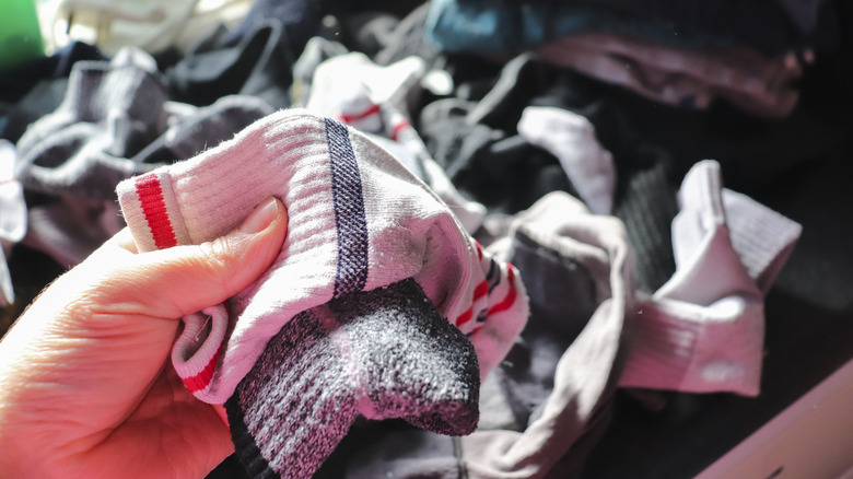 Hand holding mismatched socks