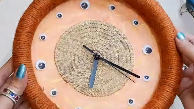 Quirky DIY clock made with garden hose and other materials