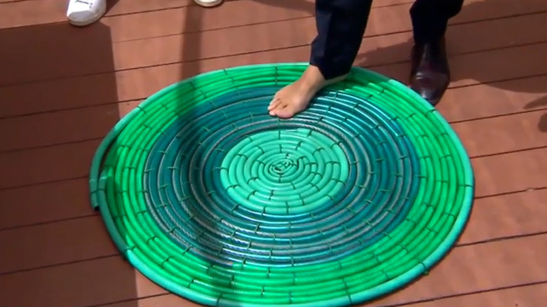 Colorful floor mat made with old garden hoses