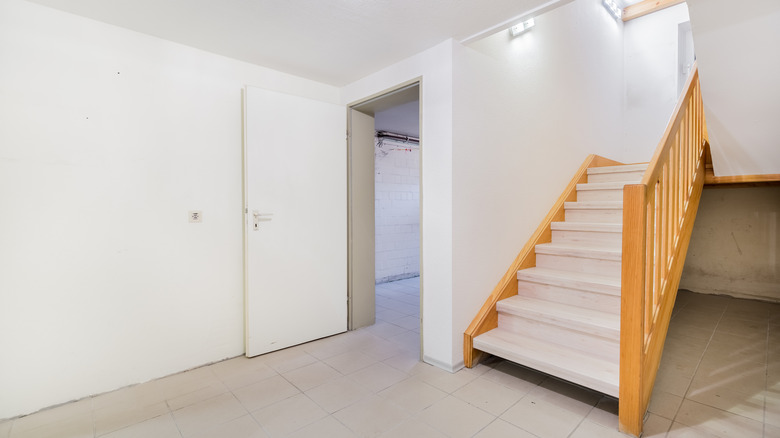 Home basement with doorway and stairs