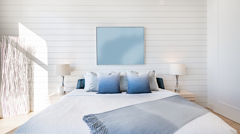 bedroom with shiplap accent bed wall