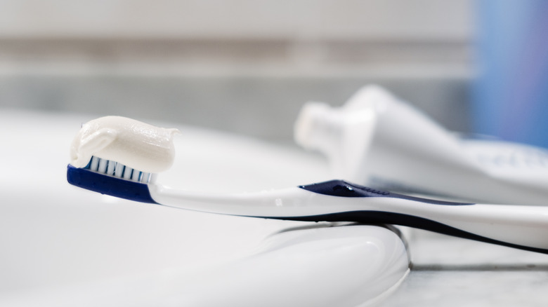 Toothbrush with toothpaste on sink