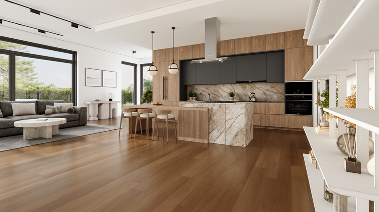 A kitchen and living room with wood floors