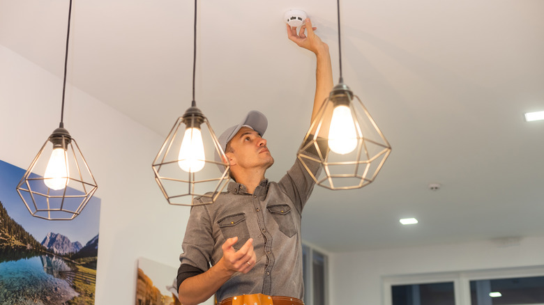 Handyman installing smoke detector