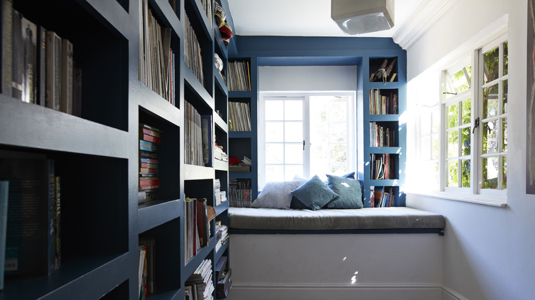 hallway and nook in home library with window seating