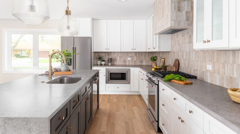 Kitchen with gray granite countertops and white cabinets