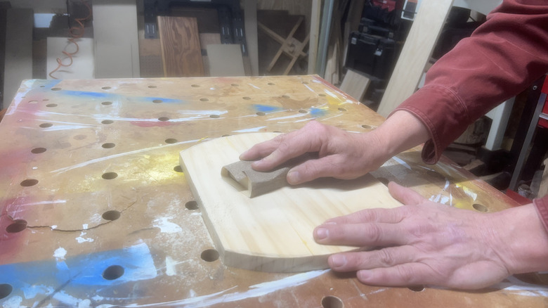 hand sanding wood cutting board