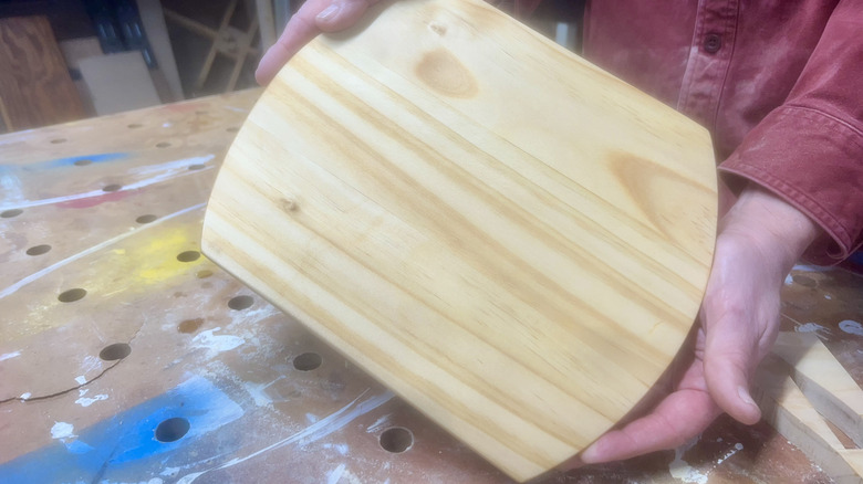 person holding cutting board