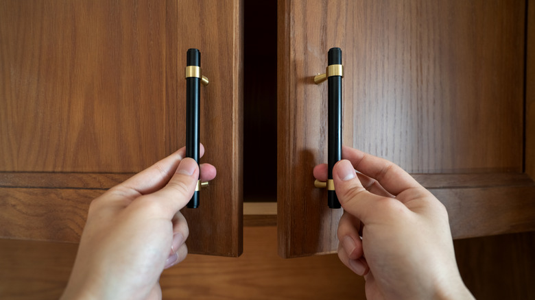 Person closing cabinet doors