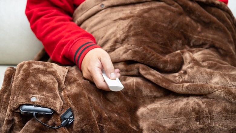 person under brown electric blanket