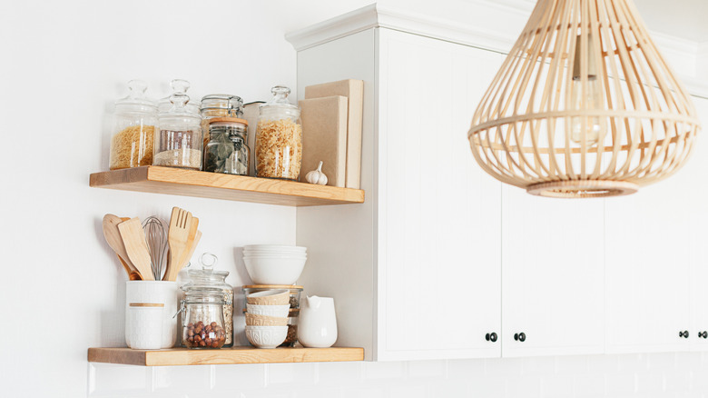 Ope wood shelving in a white ktichen