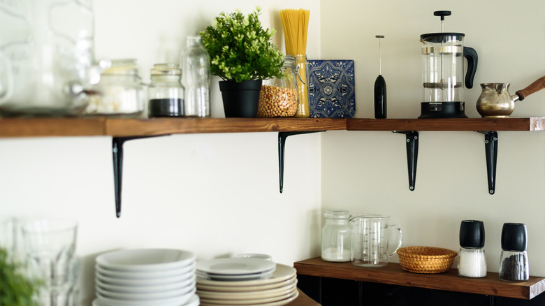 Wood shelves with dishes and a houseplant