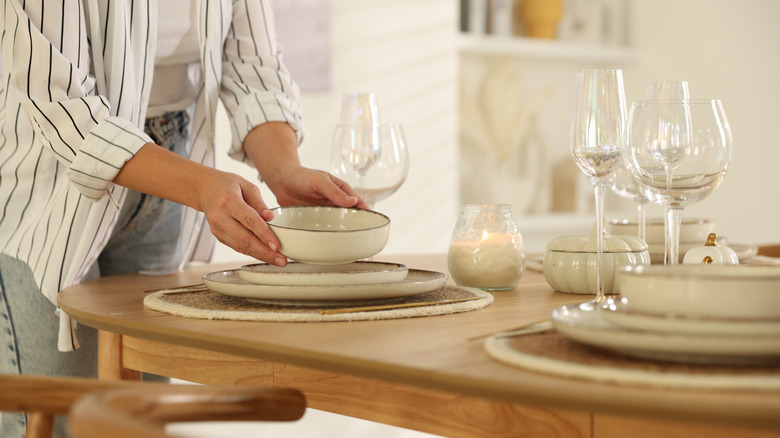 woman setting casual dinner table