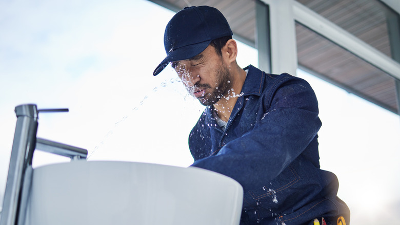 Man sprayed in face by sink faucet