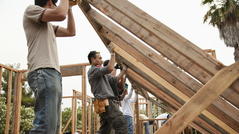 Two men framing a house