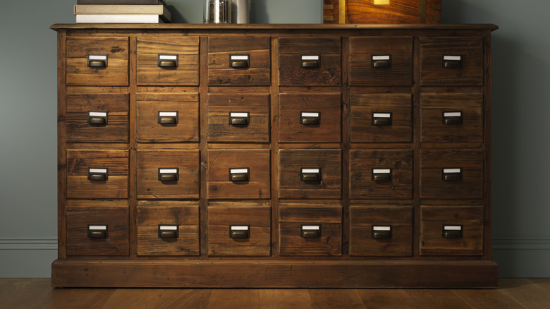 filing cabinet or apothecary chest made of dark wood