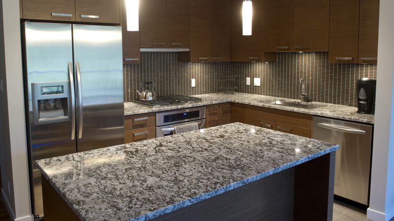 granite countertop and island in a brown kitchen