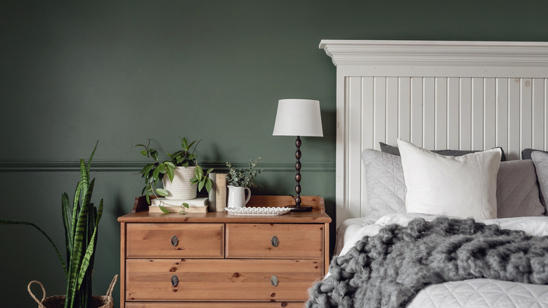 moody green wall in bedroom