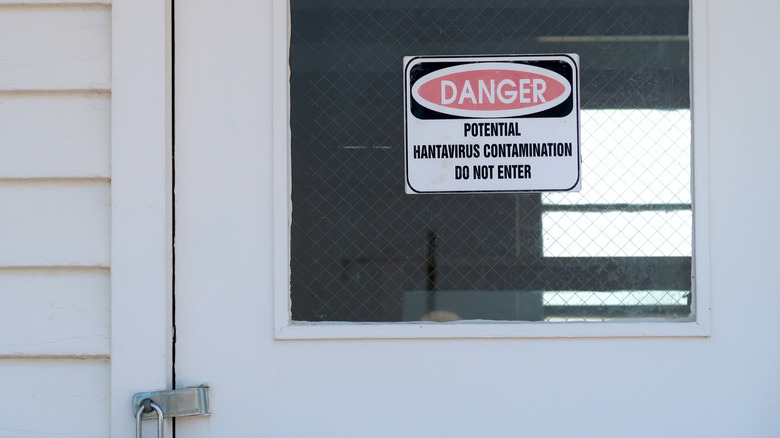 Sign on locked door warning of potential hantavirus contamination