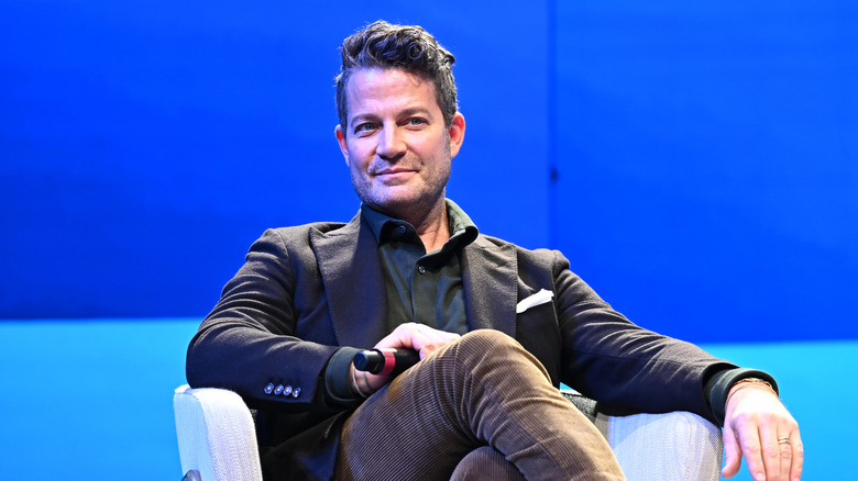 interior designer Nate Berkus sitting in a blue room