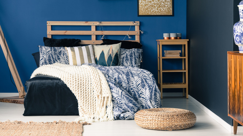 A living room is painted blue with blue and white accents and furniture throughout.