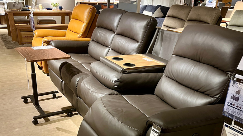 leather sofa with cup holders in a store