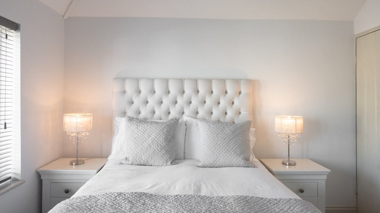 bedroom with a white upholstered headboard