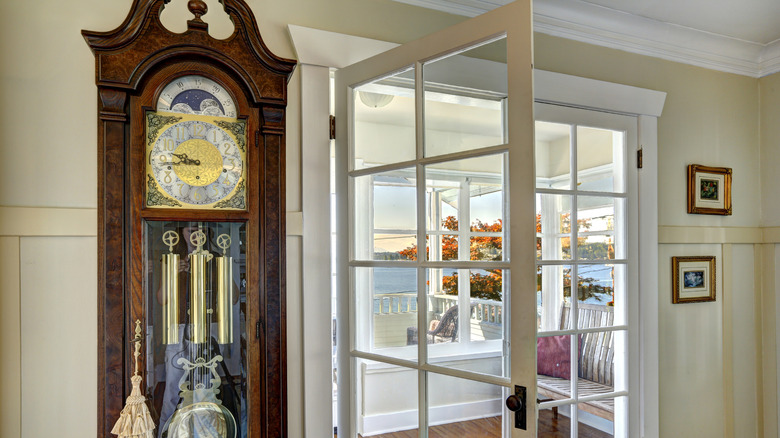 Antique grandfather clock near doorway