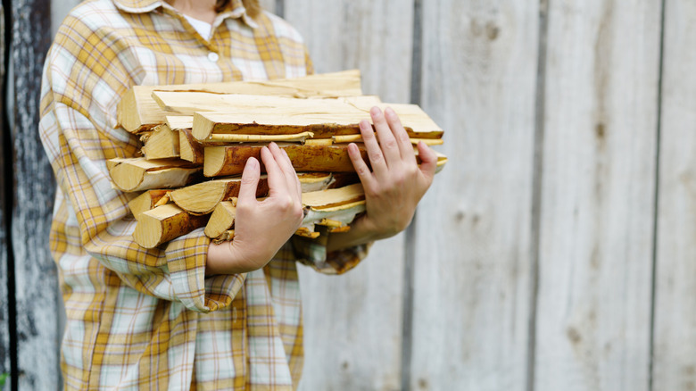 Woman holding firewood