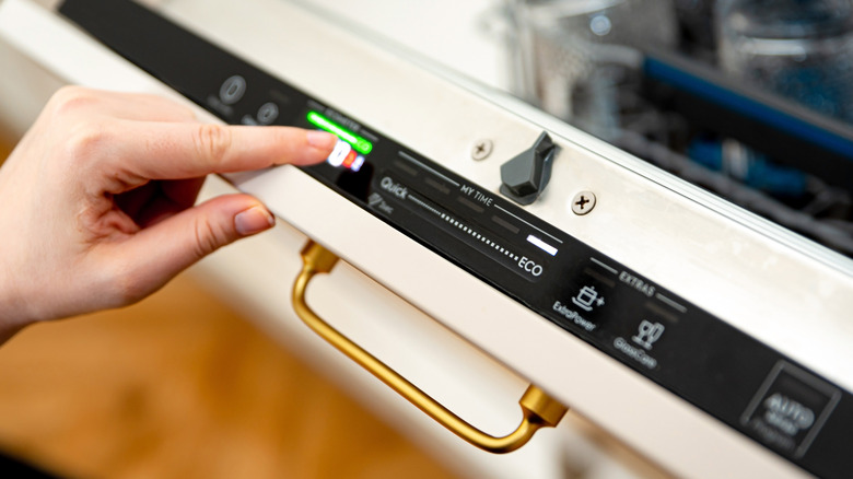 dishwasher buttons being pressed