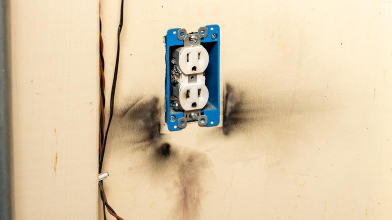 Electric receptacle surrounded by burn marks