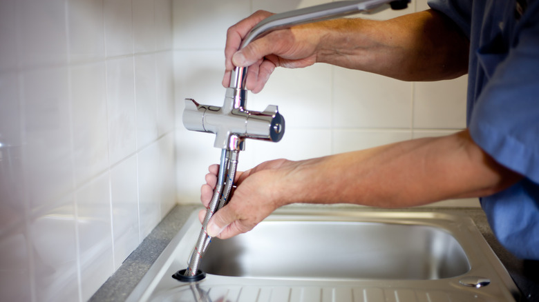 installing faucet into sink hole