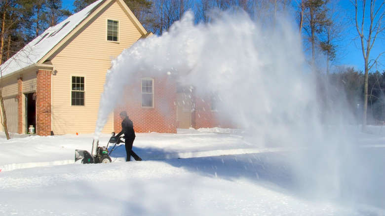 A wide shot of the arc from a snow blower.