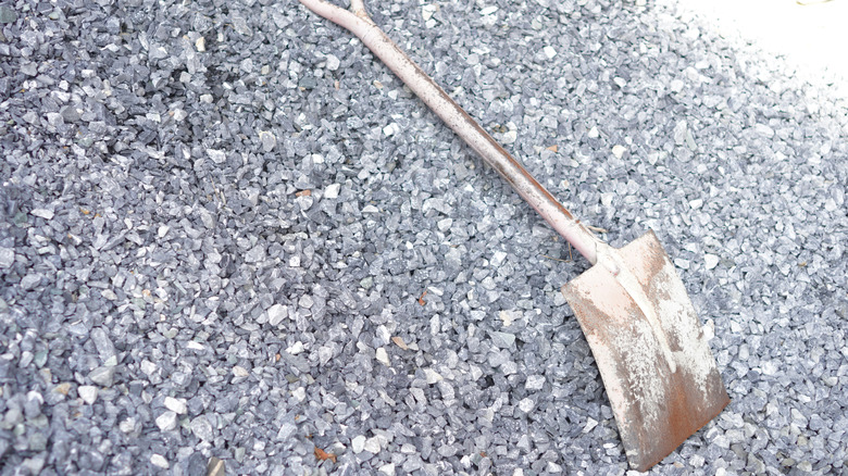 Thick layer of gravel with shovel on top