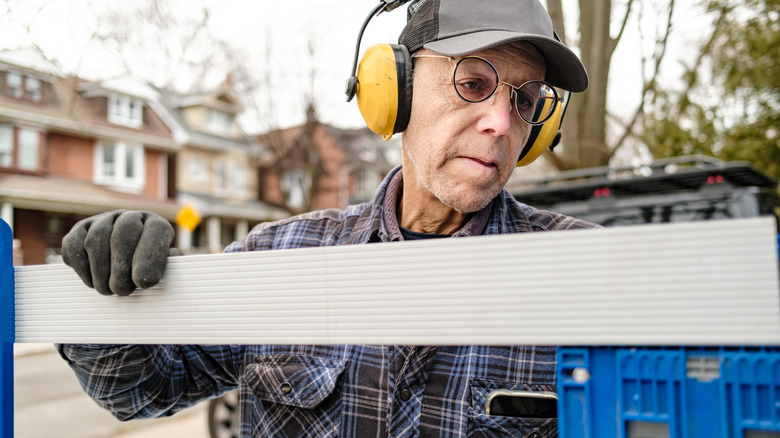 man building vinyl fence