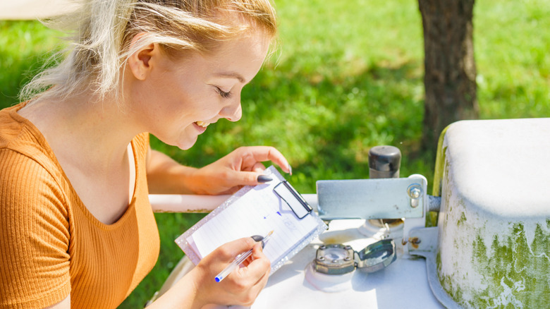 woman checking propane tank dials