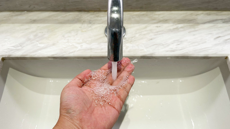 Washing hands with touchless faucet