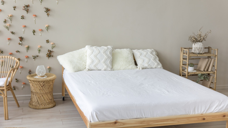 a set of white bamboo sheets surrounded by bamboo and wicker furniture