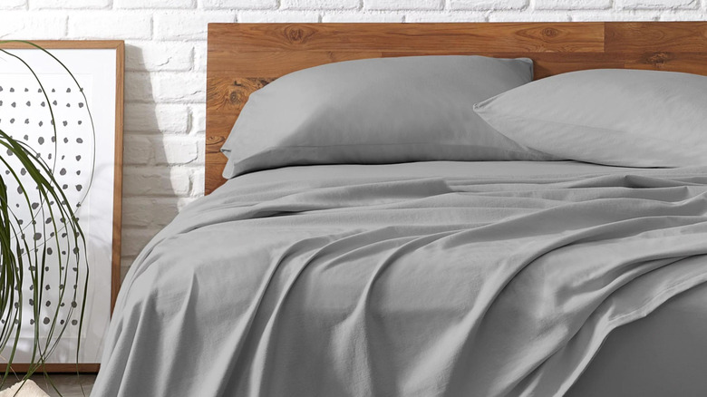 up-close shot of gray cotton sheets on a bed