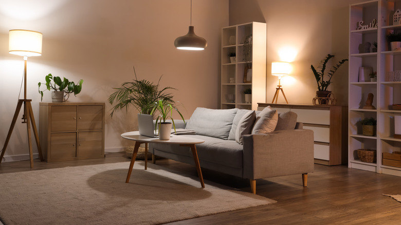 Sleek, modern gray living room with soft overhead and table lighting options