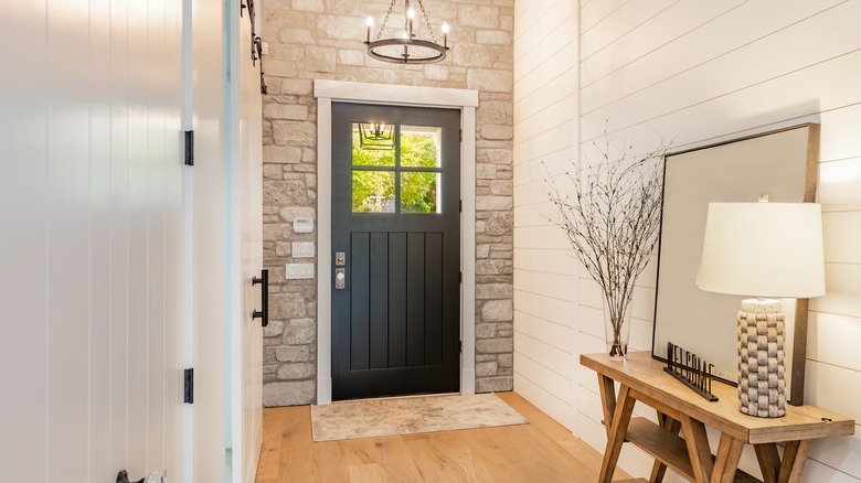 interior image of home entryway with dark colored door and white trim