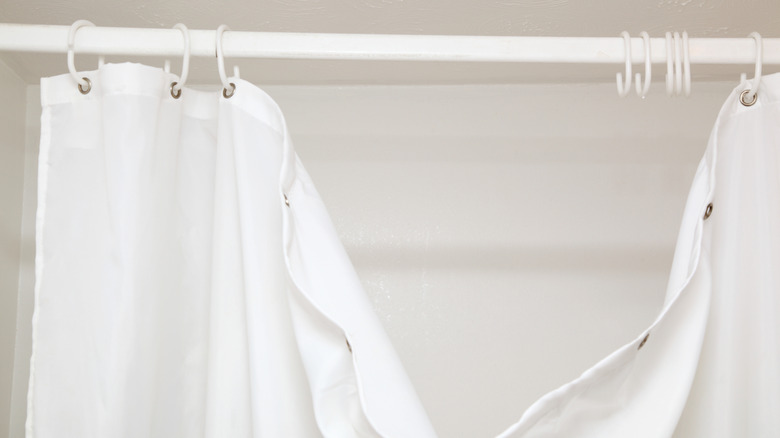 white hooked shower curtain falling off hooks