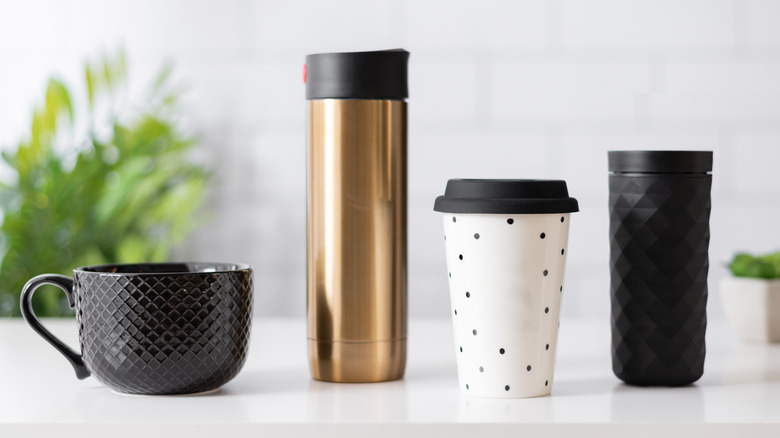 This is an assortment of coffee cup styles on a white counter.