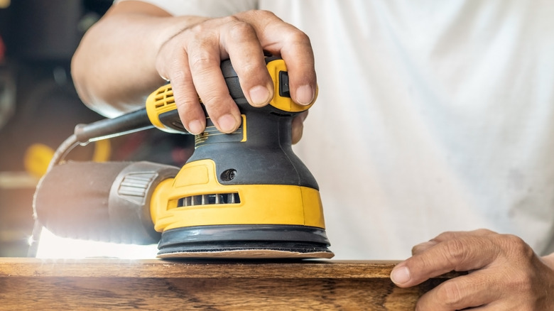 Man using hand sander