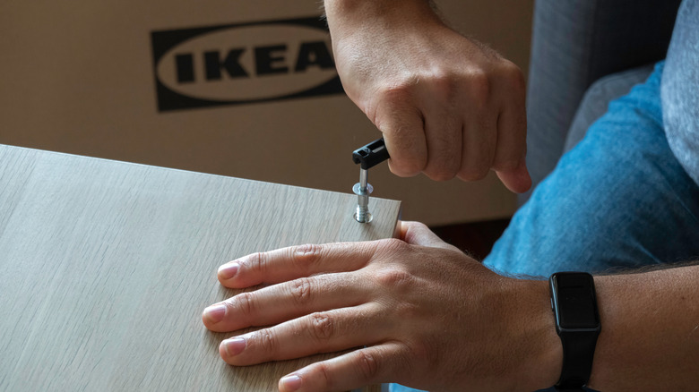 Using a hex wrench to assemble flat-pack IKEA furniture