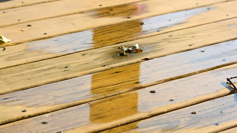 Water pooling on wooden deck