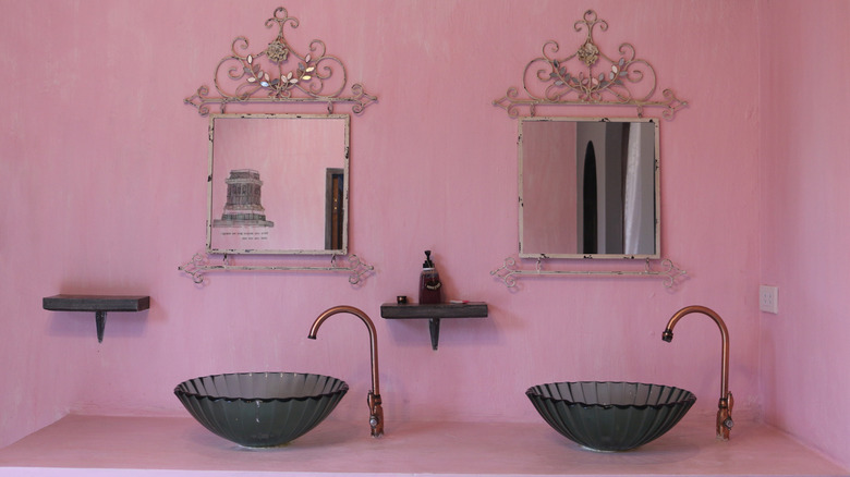 pink bathroom double vanity featuring gorgeous framed mirrors and black crystal vessel basin sinks