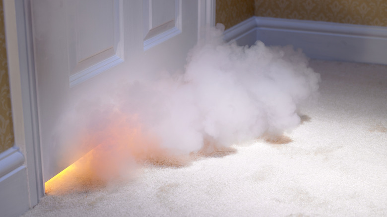 smoke coming from under a door